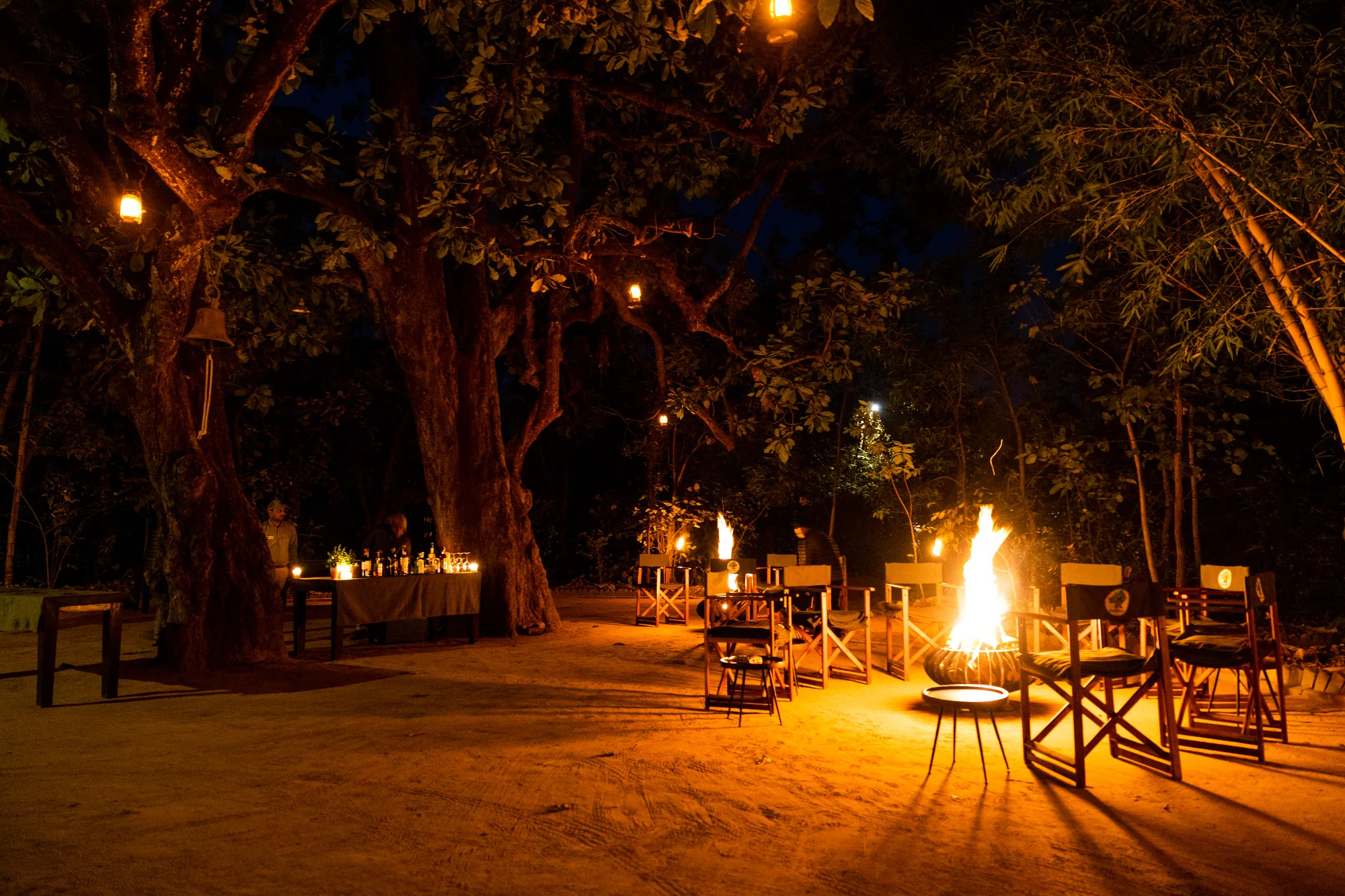 A warm fireside gathering beneath the trees at Bagh Tola